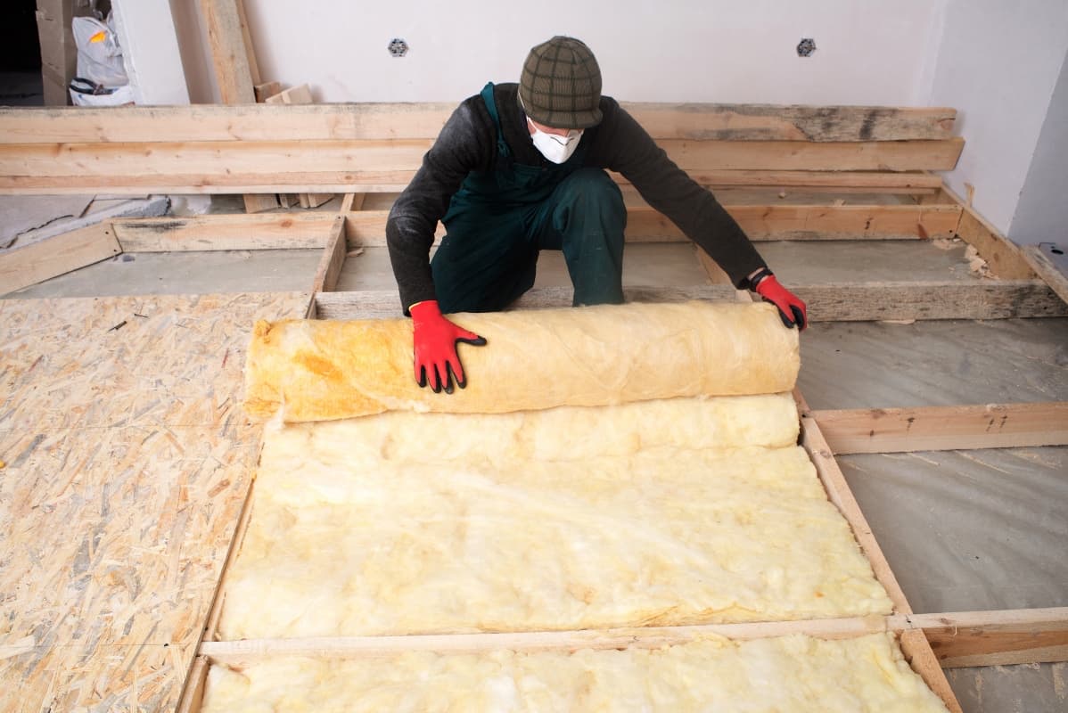 man installing foam insulation