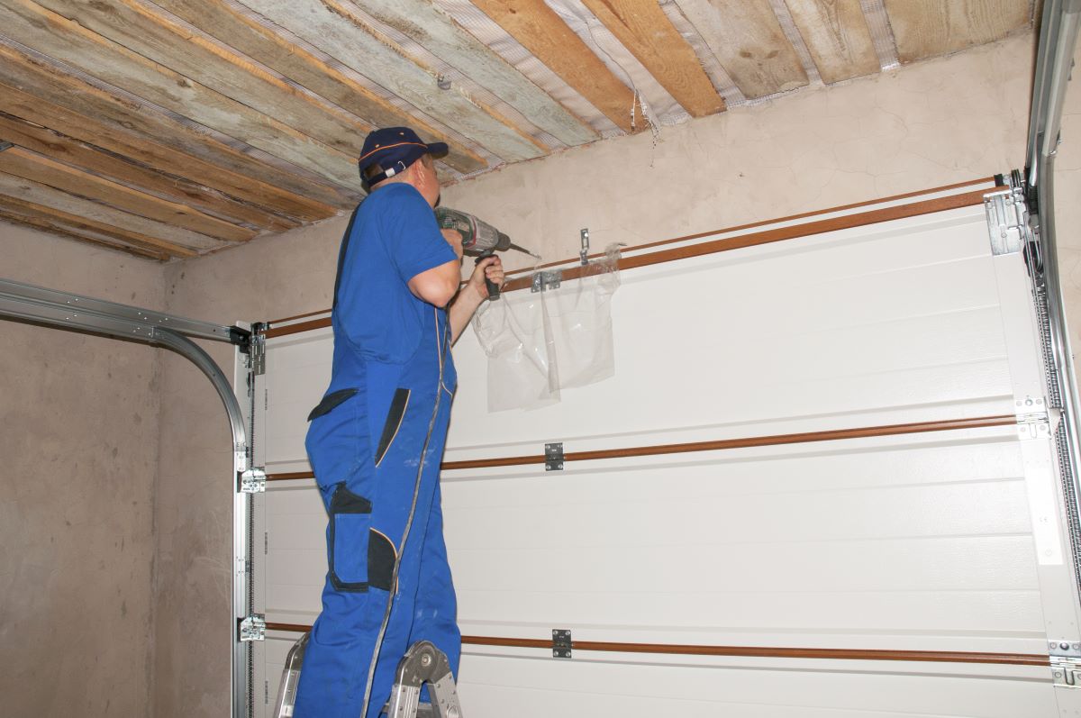 man installing garage door